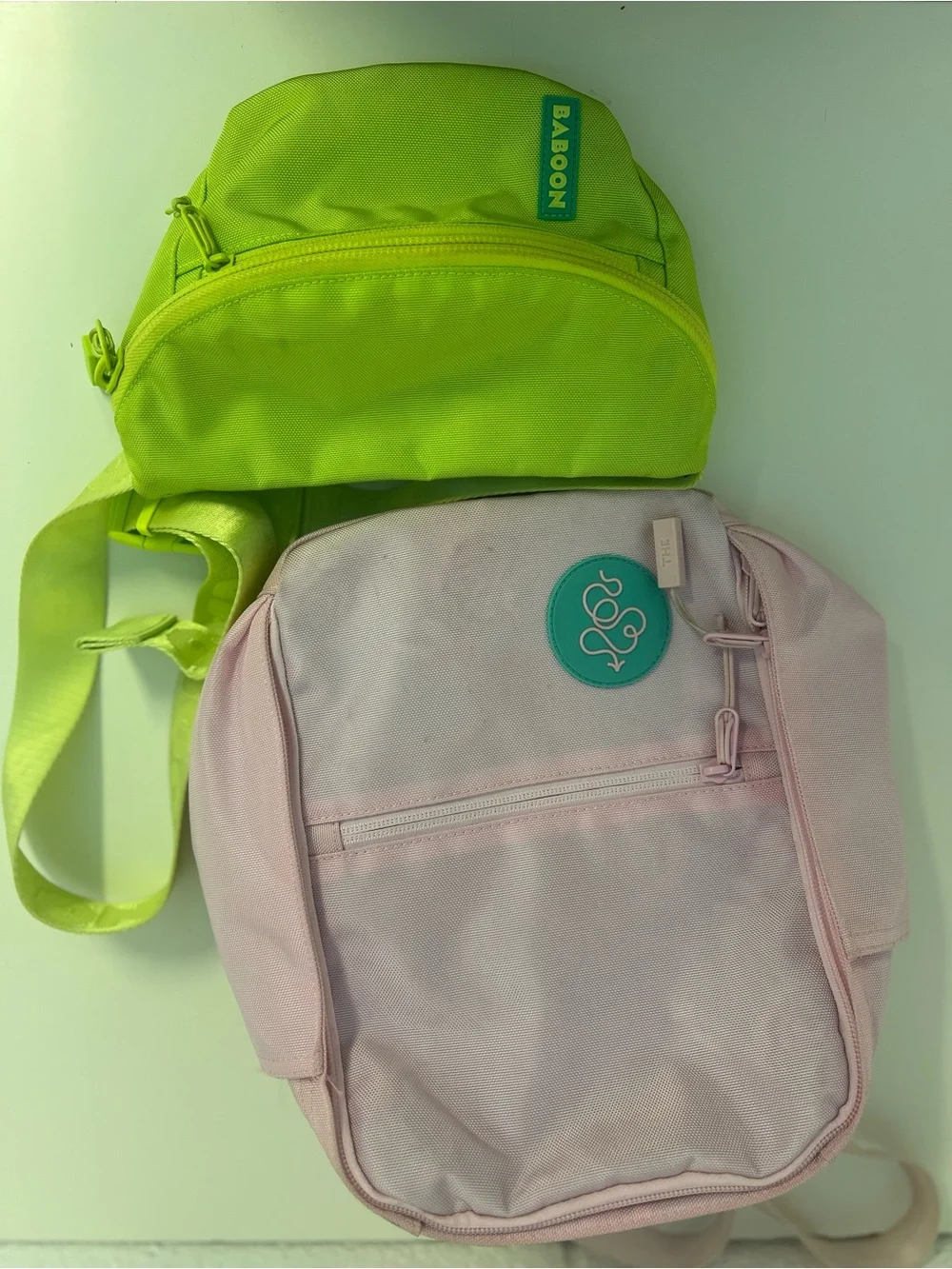 Baboon to the Moon Neon Green Waist Bag and Pink Mini Backpack Bag Duo